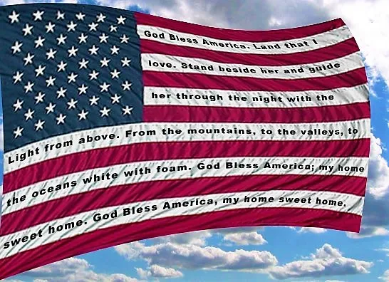 An american flag with the lyrics of "god bless america" superimposed over it, set against a sky with clouds.