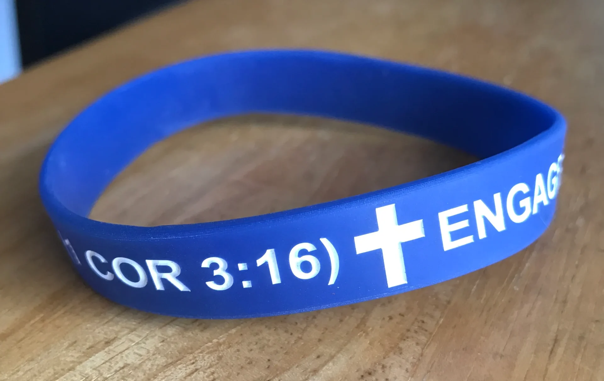 Blue silicone wristband with a religious message and scripture reference.