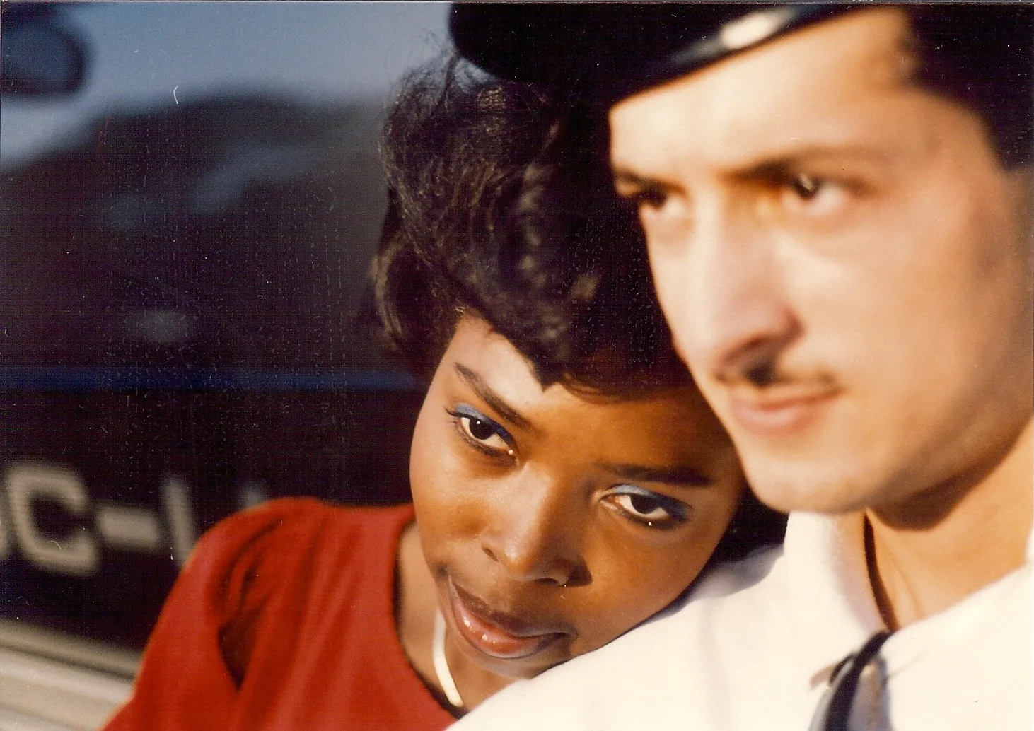 A close-up portrait of a woman and a man with a soft focus background.