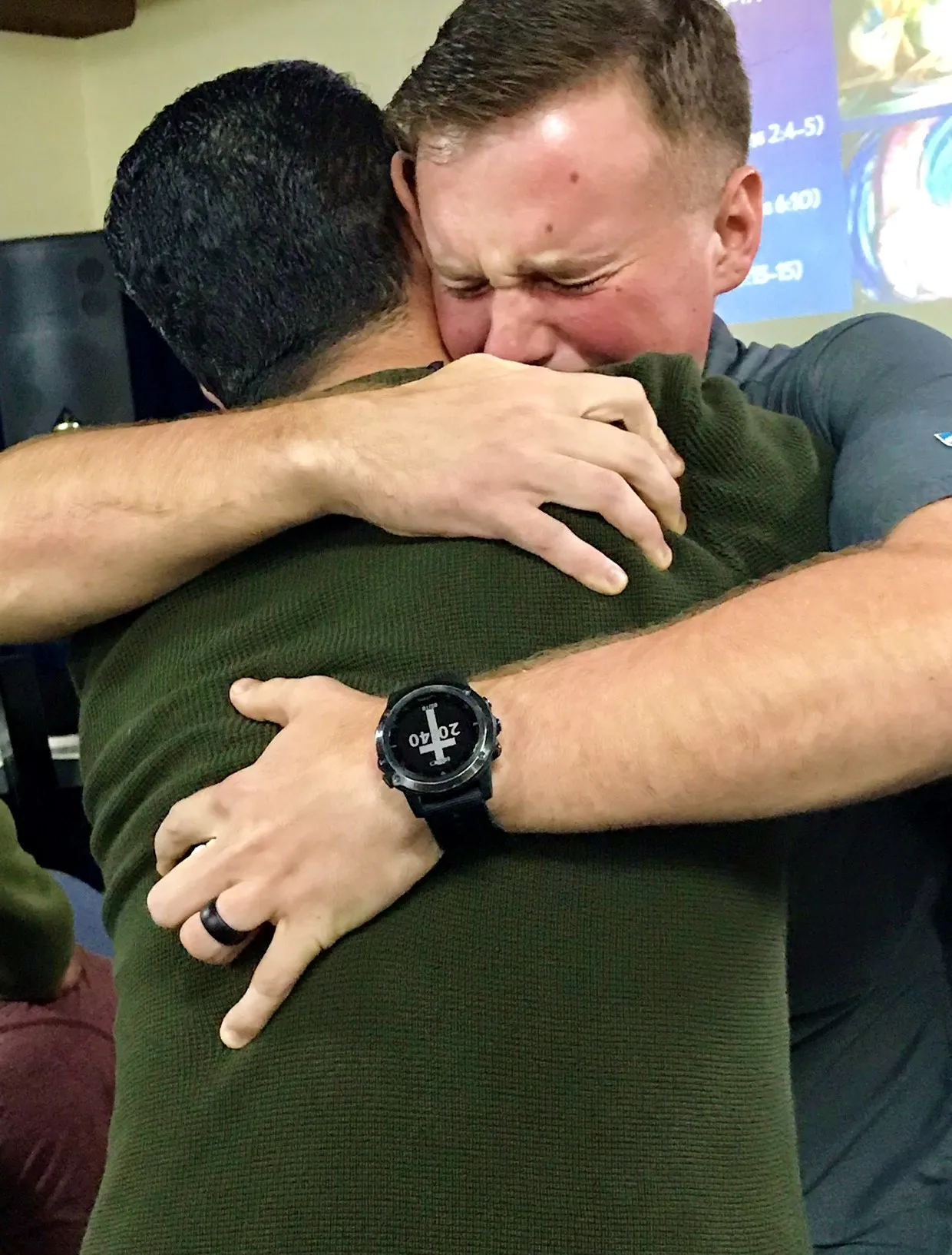 Two men embracing in a heartfelt hug.