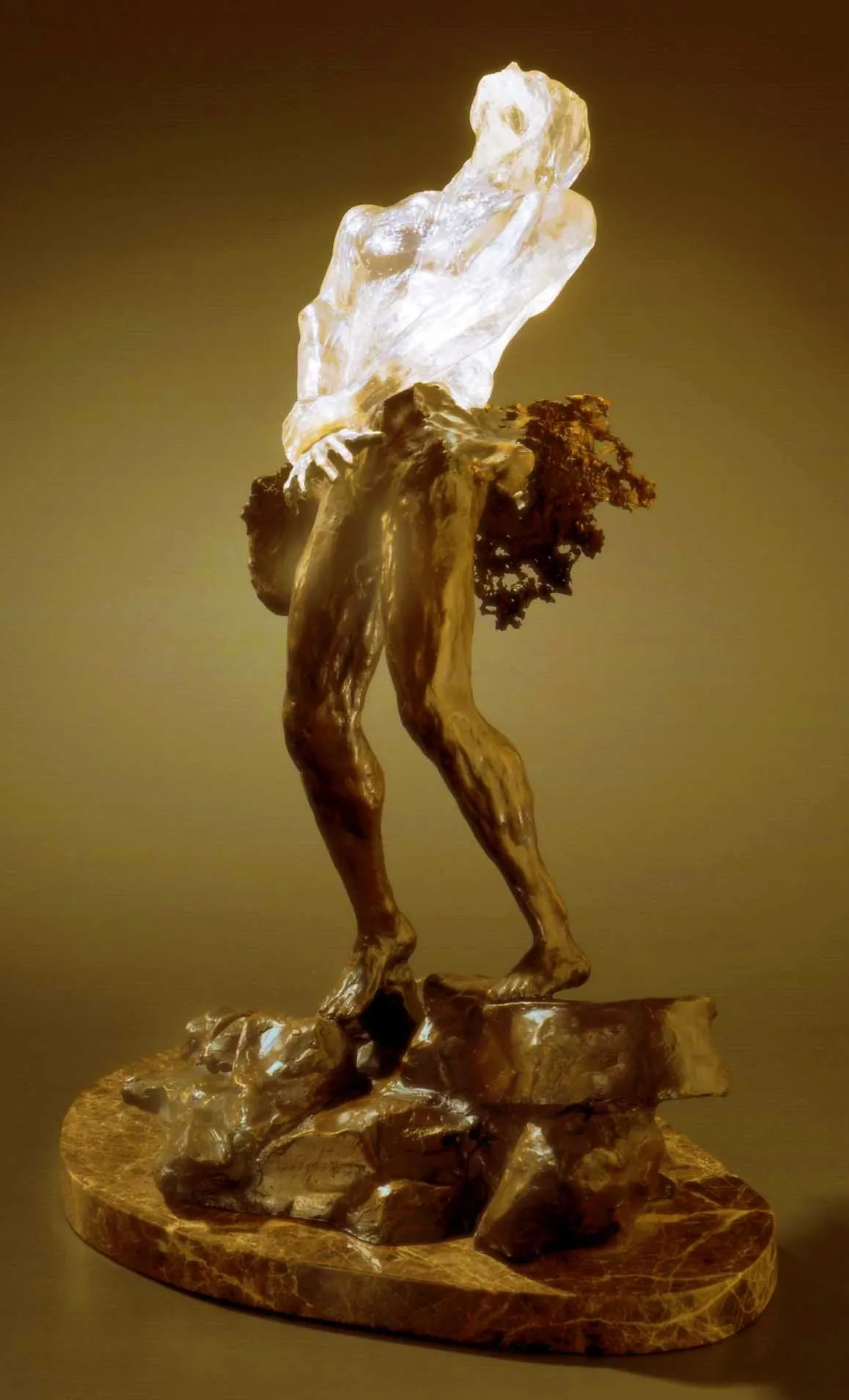 A sculpture depicting a figure with a translucent torso and solid lower body, contrasting materials to highlight form and texture.