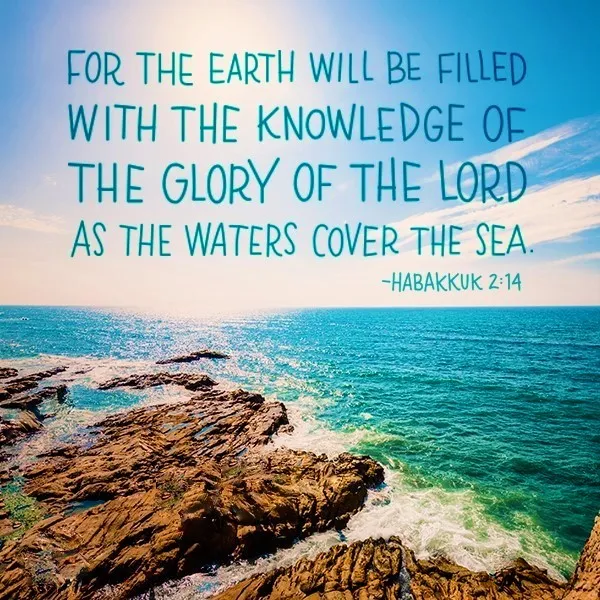 Ocean waves crashing on rocky shores with an inspirational biblical quote from habakkuk 2:14 overlaying the clear blue sky.