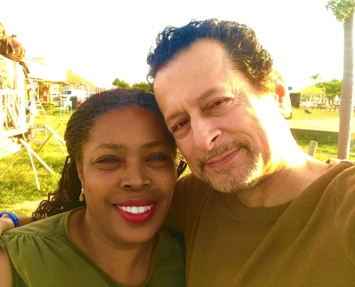 Two people smiling for a selfie in a park during daytime.