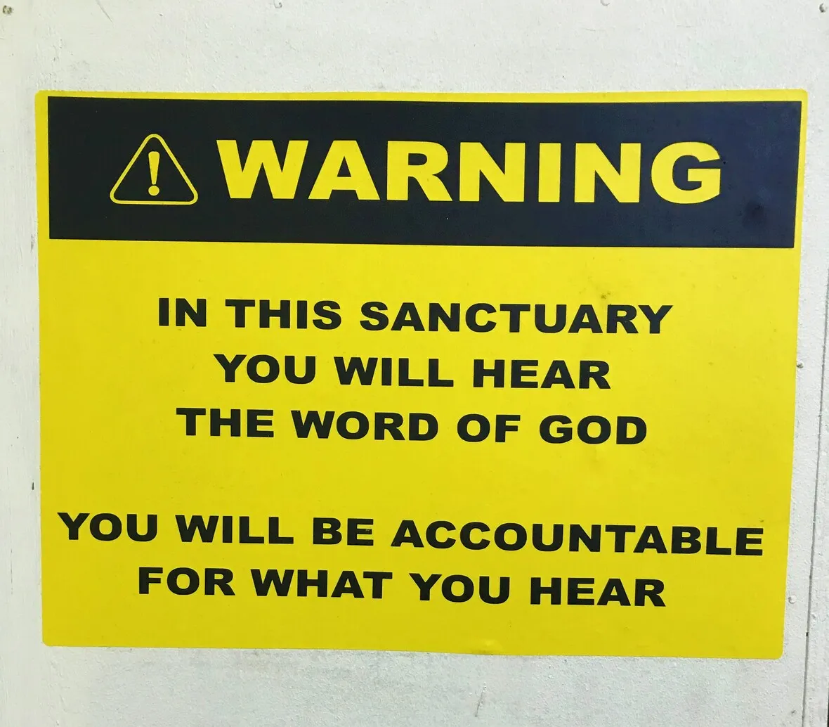 A warning sign stating that visitors will hear the word of god in the sanctuary and will be accountable for what they hear.