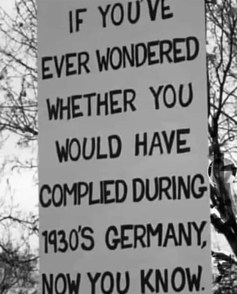 Sign posing a reflective question about compliance relating to 1930s germany.