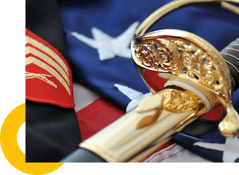 A ceremonial military sword, embodying spiritual guidance, lying on top of an American flag.
