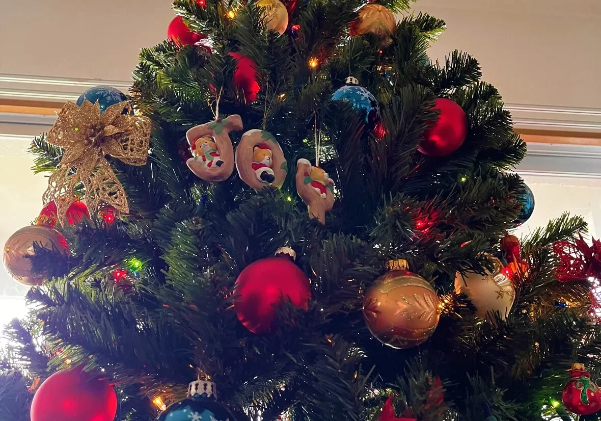 A decorated christmas tree with colorful ornaments and a star topper.