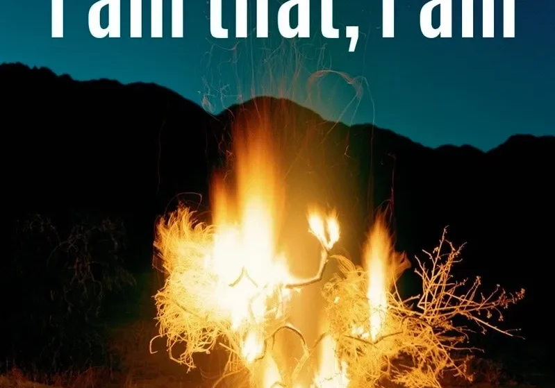 A blazing bonfire in the night with the phrase "i am that, i am" overlaid in white text.