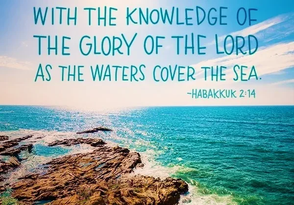 Ocean waves crashing on rocky shores with an inspirational biblical quote from habakkuk 2:14 overlaying the clear blue sky.