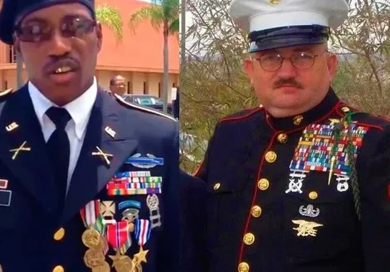 Two men in military uniforms with numerous medals and ribbons displayed on their chests.