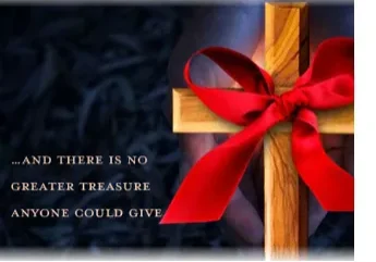 A wooden cross adorned with a red ribbon against a blurred background with an inspirational message.