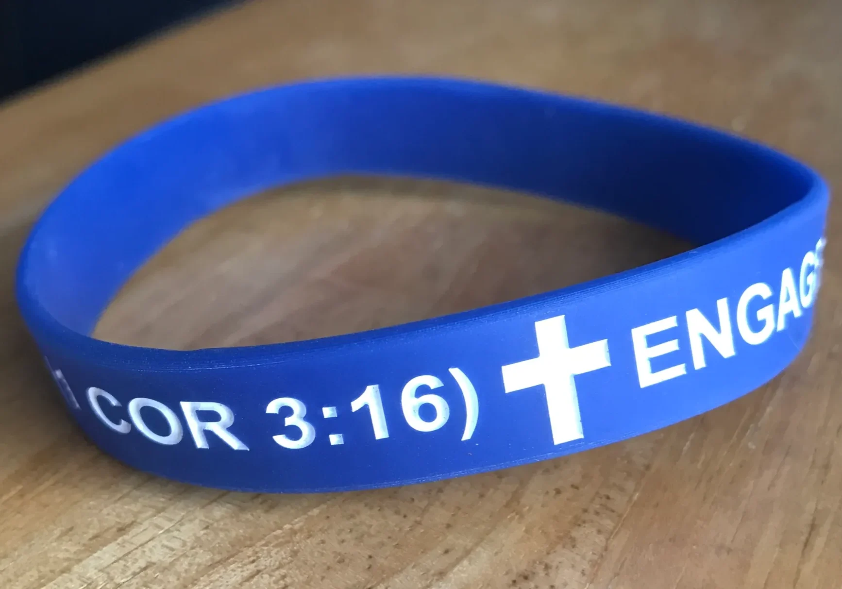 Blue silicone wristband with a religious message and scripture reference.