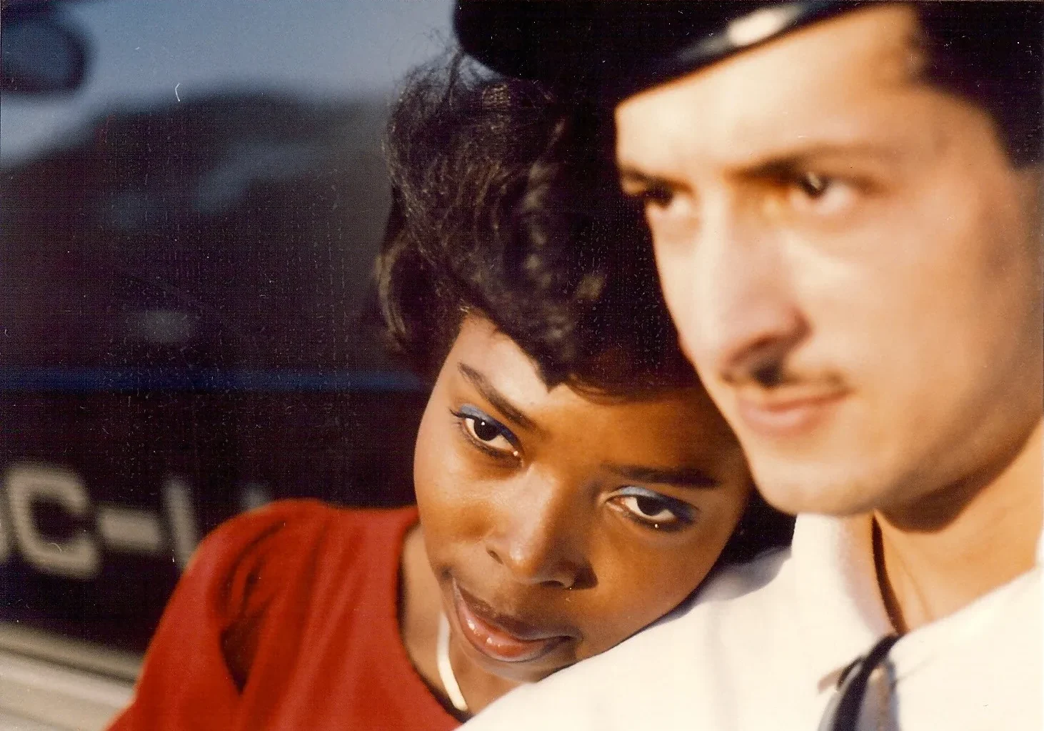 A close-up portrait of a woman and a man with a soft focus background.