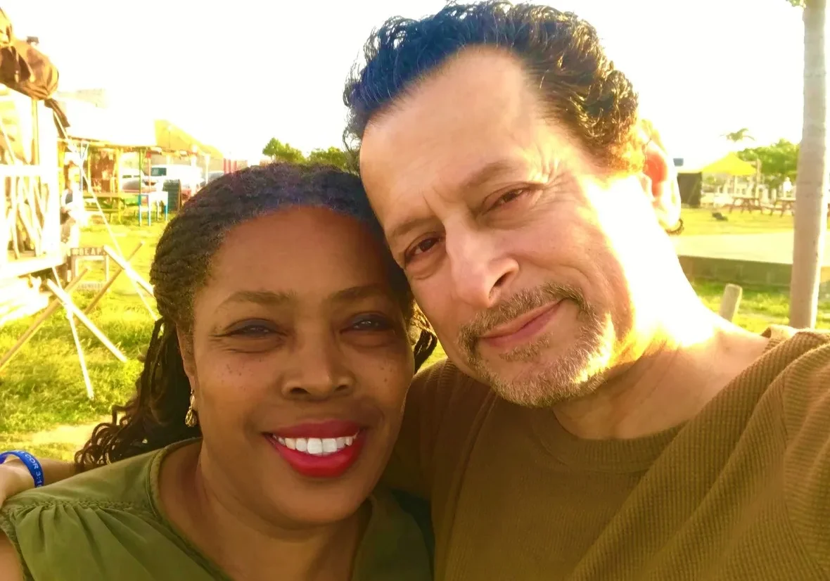 Two people smiling for a selfie in a park during daytime.