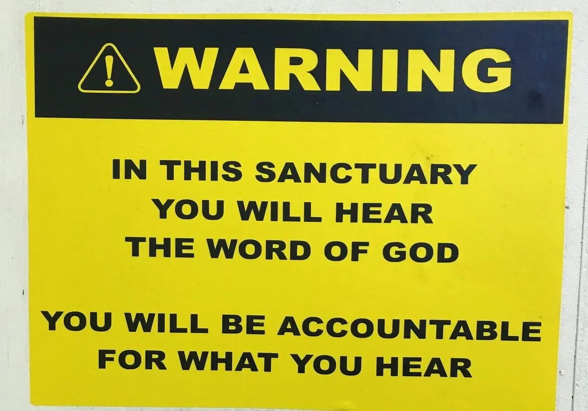 A warning sign stating that visitors will hear the word of god in the sanctuary and will be accountable for what they hear.